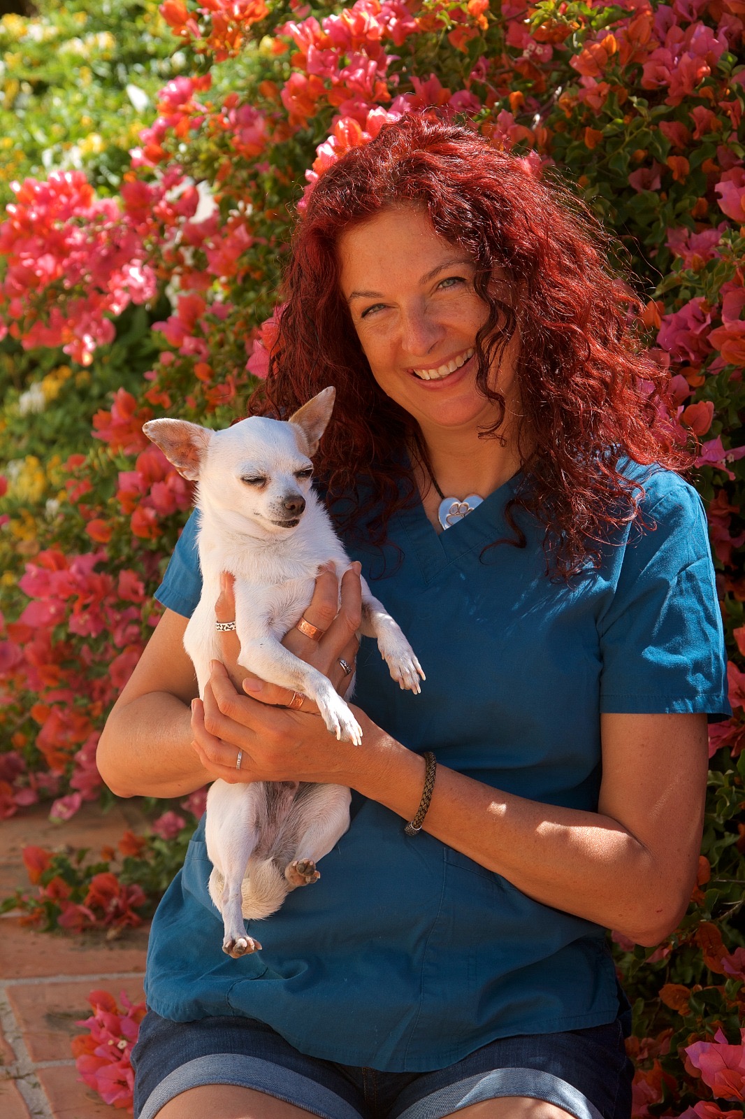 Gunila smiling with a chihuahua